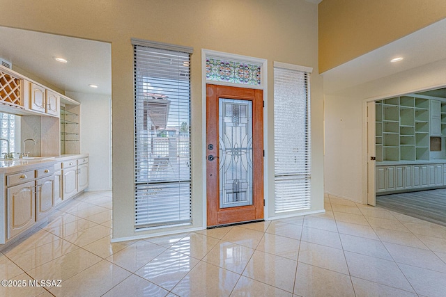 entrance foyer with light tile patterned flooring and recessed lighting