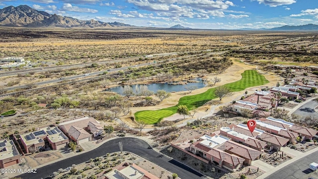 drone / aerial view featuring a residential view, view of golf course, and a water and mountain view