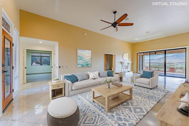 living room featuring ceiling fan, high vaulted ceiling, and light tile patterned flooring