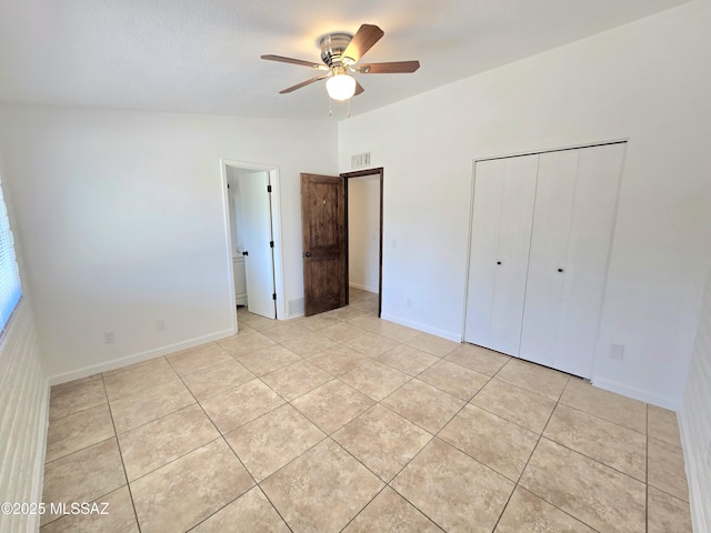 unfurnished bedroom featuring light tile patterned floors, baseboards, visible vents, and a closet