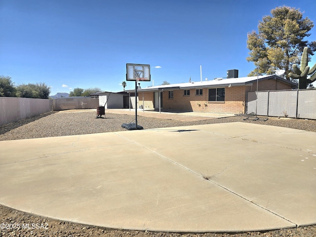 view of basketball court featuring fence private yard