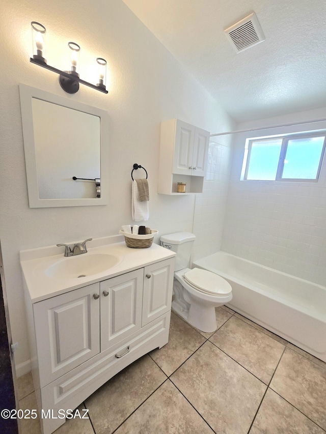 bathroom featuring visible vents, toilet, a textured ceiling, vanity, and tile patterned floors