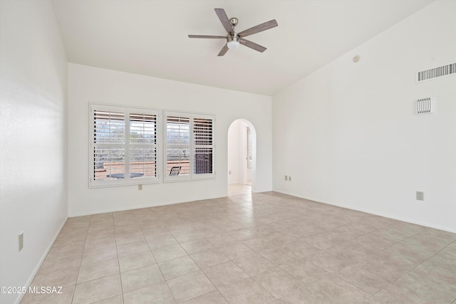 unfurnished room with arched walkways, ceiling fan, light tile patterned floors, and visible vents