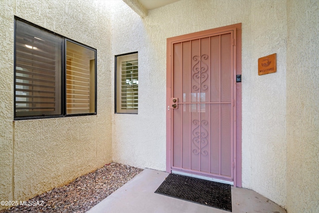 doorway to property with stucco siding