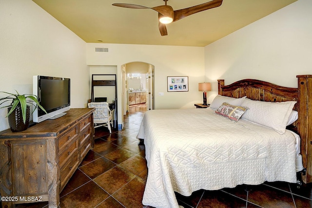 bedroom featuring arched walkways, visible vents, and ceiling fan