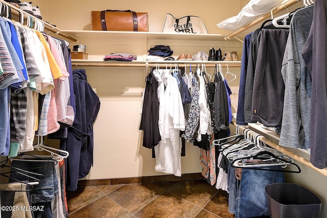 spacious closet featuring dark tile patterned floors