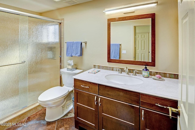 bathroom featuring a stall shower, vanity, and toilet