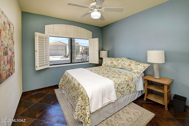 bedroom featuring a ceiling fan and baseboards