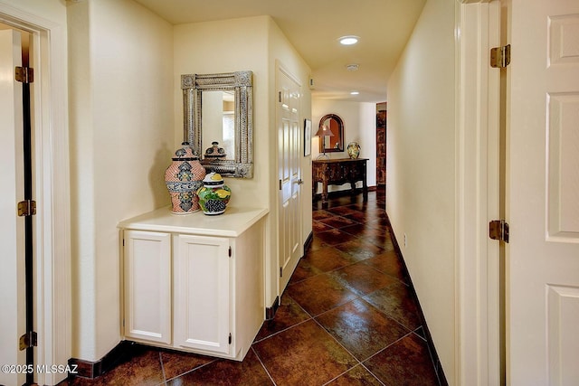 hallway featuring baseboards