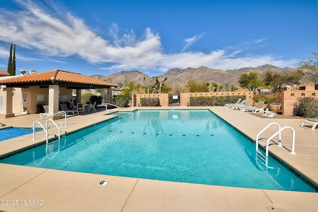 pool with a gazebo, fence, a mountain view, and a patio