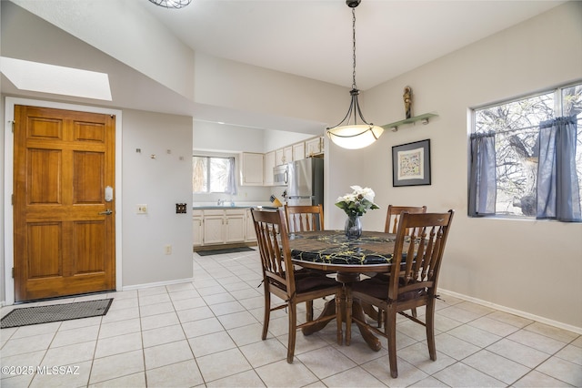 dining room featuring light tile patterned floors and baseboards