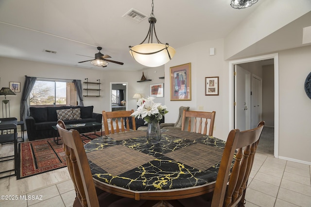 dining space featuring light tile patterned floors, ceiling fan, and visible vents