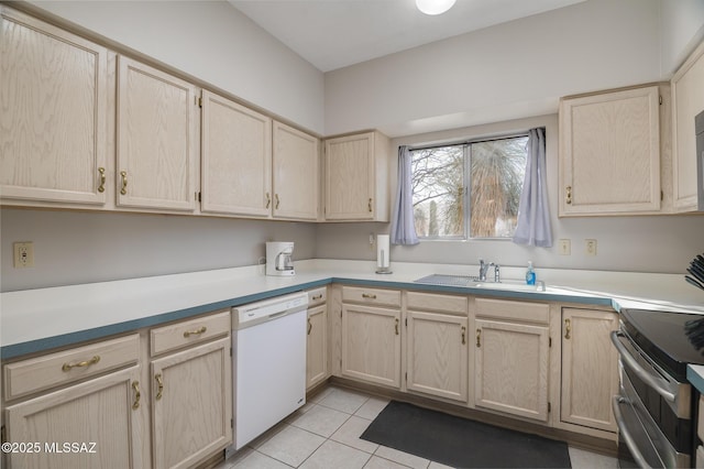 kitchen featuring double oven range, white dishwasher, light brown cabinets, and light tile patterned flooring