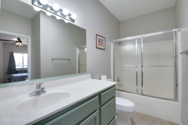 ensuite bathroom featuring bath / shower combo with glass door, toilet, ensuite bath, tile patterned flooring, and vanity