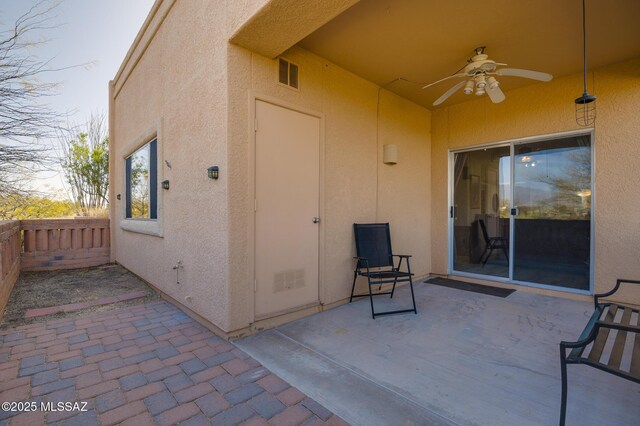 view of patio / terrace featuring visible vents, ceiling fan, and fence