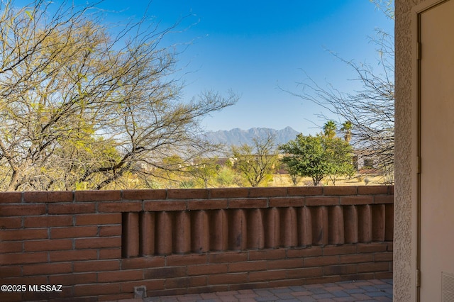 exterior space featuring visible vents, fence, and a mountain view