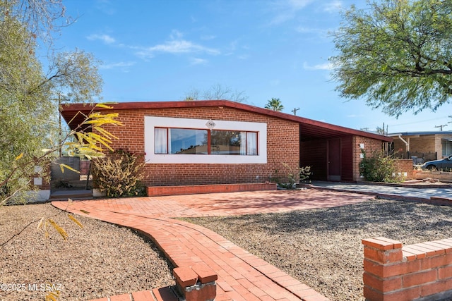 view of front of home featuring brick siding