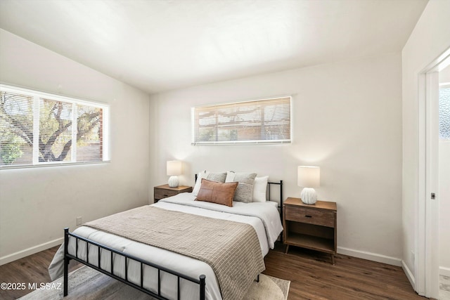 bedroom featuring dark wood-style floors and baseboards