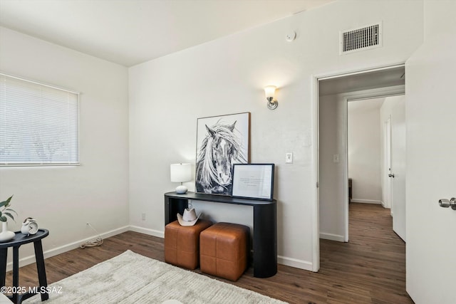 office featuring dark wood-style flooring, visible vents, and baseboards