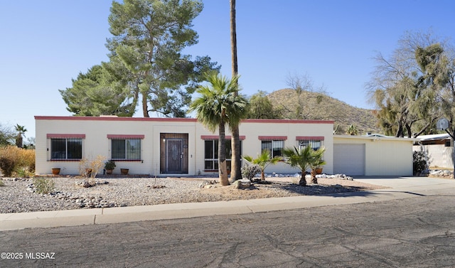 view of front of property with a garage and concrete driveway