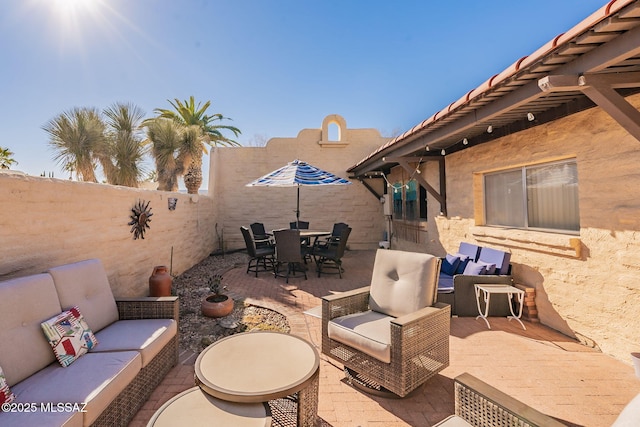 view of patio / terrace with outdoor dining area, outdoor lounge area, and a fenced backyard