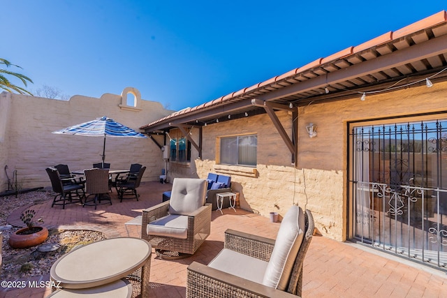 view of patio / terrace with outdoor dining space and fence