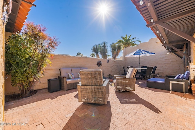 view of patio / terrace with a fenced backyard, an outdoor living space, and a pergola