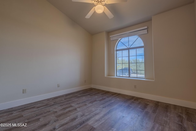 empty room with lofted ceiling, a ceiling fan, baseboards, and wood finished floors