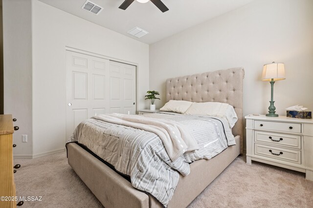 bedroom featuring light carpet, a ceiling fan, and baseboards