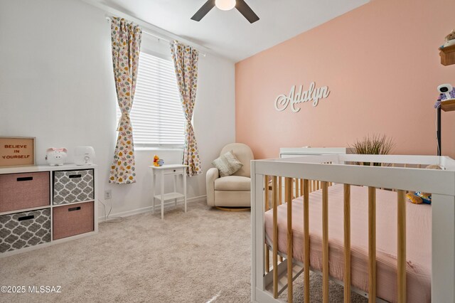 carpeted bedroom featuring a ceiling fan, visible vents, vaulted ceiling, and a crib