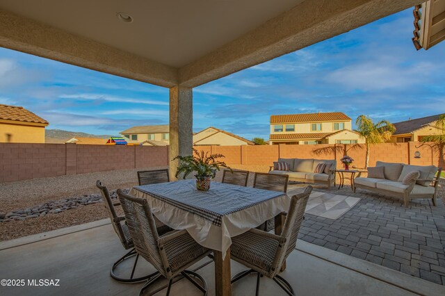 view of patio with outdoor dining area, outdoor lounge area, and fence