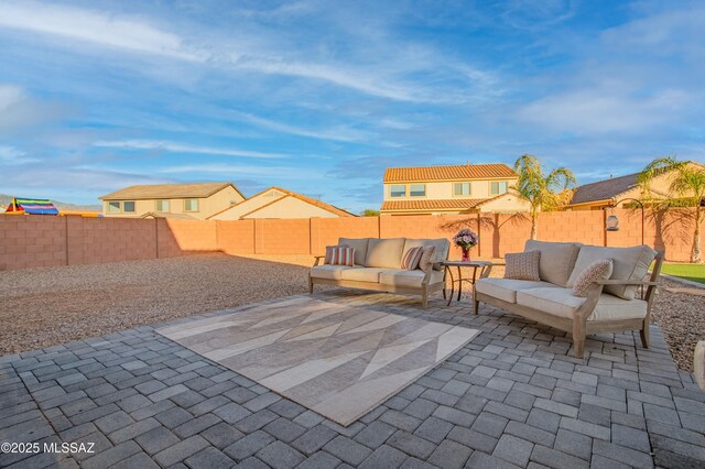 view of patio featuring outdoor dining area, a fenced backyard, and an outdoor living space