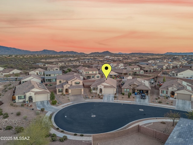 aerial view at dusk with a mountain view and a residential view