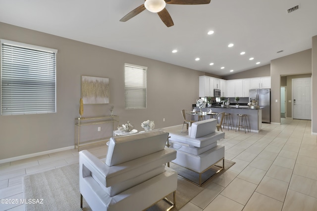 living area with light tile patterned floors, visible vents, ceiling fan, vaulted ceiling, and recessed lighting