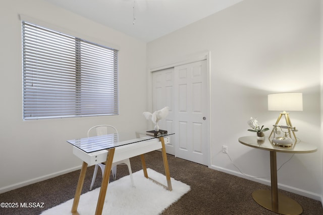 office area featuring dark carpet and baseboards