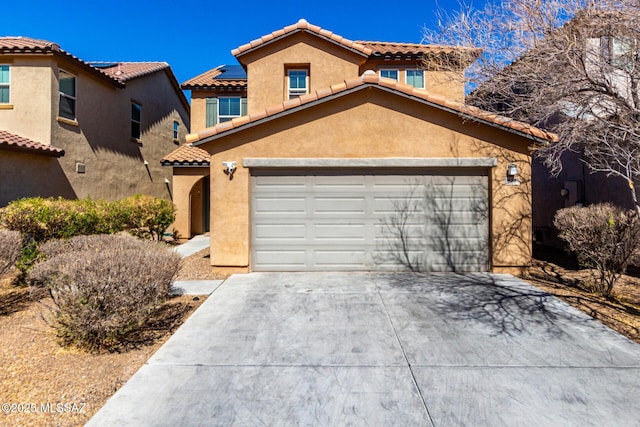 mediterranean / spanish-style home featuring a garage, a tile roof, driveway, and stucco siding