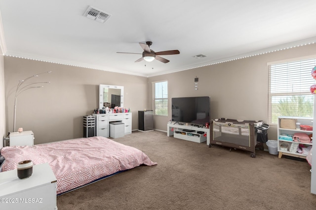 bedroom featuring visible vents, crown molding, and carpet flooring