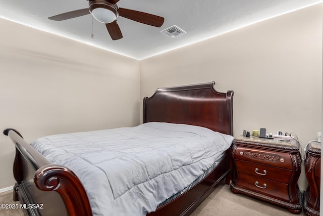 bedroom with light colored carpet, visible vents, and ceiling fan