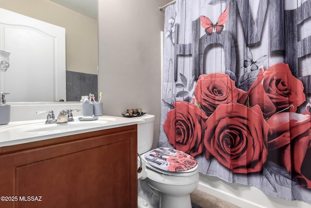 full bathroom with toilet and vanity