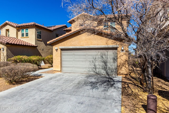 view of front of house with concrete driveway, a tiled roof, and stucco siding