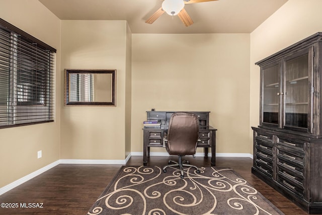 office space with a ceiling fan, dark wood-style flooring, and baseboards