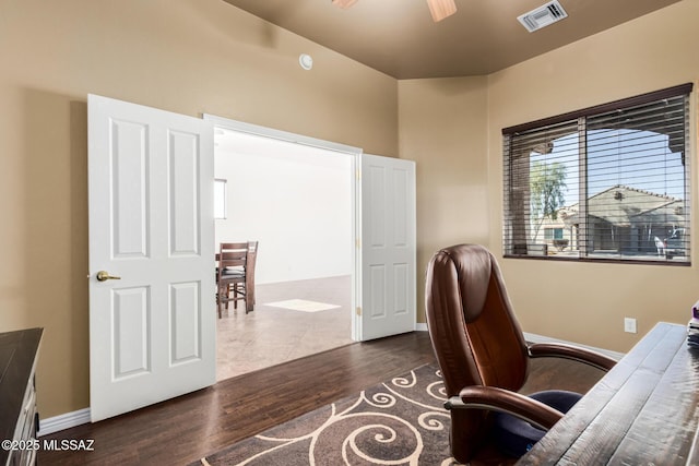 office space with visible vents, dark wood finished floors, and baseboards