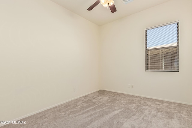 unfurnished room featuring baseboards, ceiling fan, visible vents, and light colored carpet