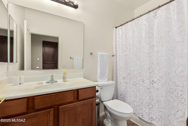 bathroom featuring toilet and vanity