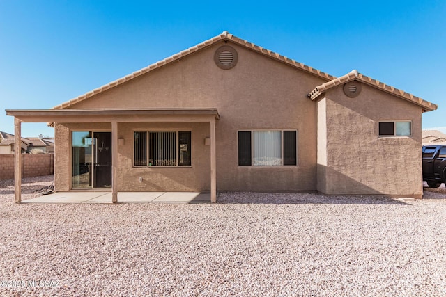 back of house with a patio area, fence, and stucco siding