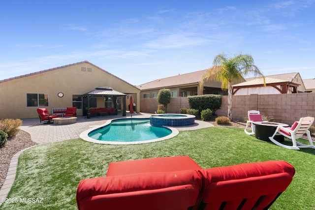 view of swimming pool with an outdoor living space with a fire pit, a patio, a pool with connected hot tub, a gazebo, and a fenced backyard