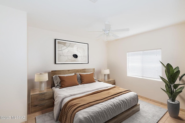 tiled bedroom with ceiling fan