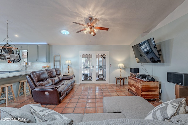 living room with ceiling fan, french doors, and light tile patterned floors