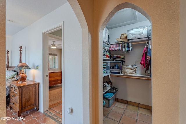 hall featuring tile patterned floors and arched walkways