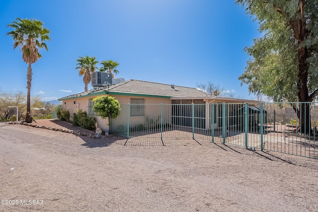 back of house with fence, a tile roof, stucco siding, cooling unit, and a patio area